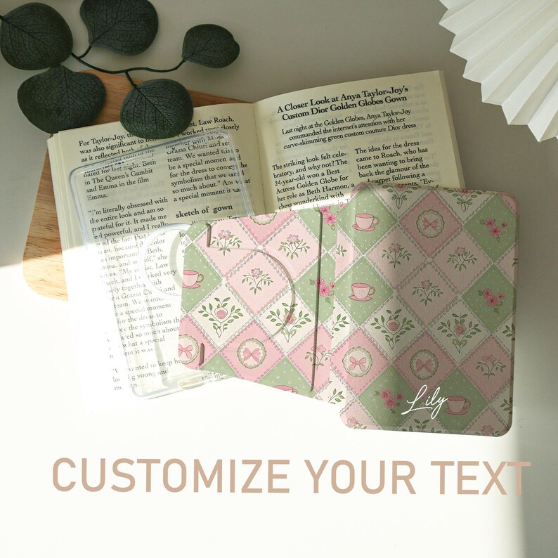 May include: A floral patterned book cover in pink and green, with a bow and teacup design. The cover is open, revealing a book. The text "Customize Your Text" is at the bottom.
