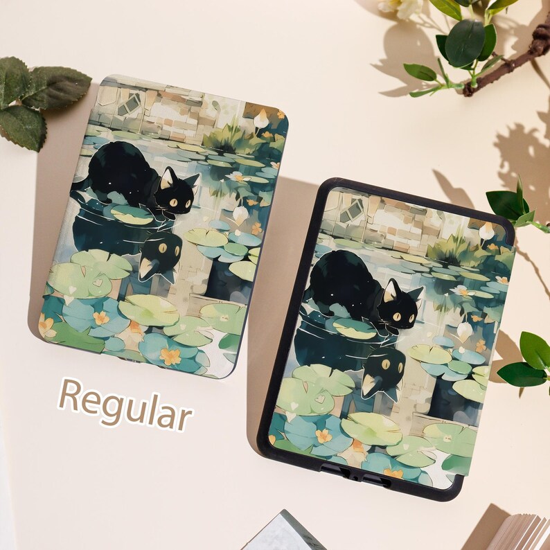 May include: Two tablet cases with a black cat illustration on a pond with lily pads. The cases have a black border and a watercolor-style design. The word "Regular" is printed on the bottom left of the image.