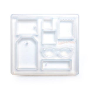 May include: A clear silicone mould featuring several shapes, including rectangular frames, a tag, and spectacles. The mould is designed for crafting and has the text "Sophie & Toffee".