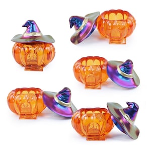 May include: Several orange glass pumpkin-shaped containers with iridescent witch hats. The pumpkins have a door design on the front. The hats are purple, blue, and gold. A festive Halloween decoration.