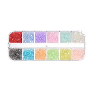 May include: A rectangular, white plastic container filled with twelve compartments of colorful, crushed glass. The colors include red, blue, purple, pink, teal, clear, black, turquoise, orange, green, yellow, and light pink. The container is on a white background.