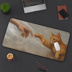 May include: A rectangular mousepad featuring a parody of Michelangelo's 'The Creation of Adam,' with a ginger cat reaching towards a human hand. A white computer mouse rests on the pad. The background depicts a cloudy sky.