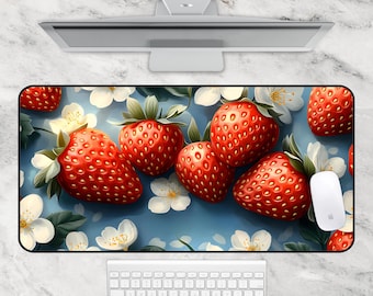 May include: A blue and white mousepad with a design of red strawberries and white flowers. The mousepad is made of a soft, smooth material and is perfect for use with a computer mouse.