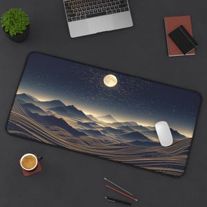May include: A black and gold mouse mat with a starry night sky and mountain landscape design. The moon is visible in the sky, and there are gold lines throughout the design.