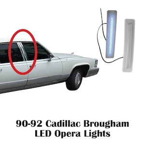 May include: Two rectangular LED opera lights for a 1990-1992 Cadillac Brougham. One light is illuminated with a cool blue glow, while the other is unlit. Each unit features a black wire lead and a slim, elongated housing designed for vehicle trim.
