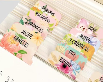 May include: A set of colorful floral patterned bookmarks with Spanish text for different books of the Bible. The bookmarks are pink, yellow, blue, and green with floral designs.