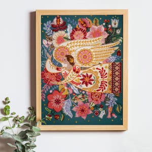 May include: A framed beaded artwork depicting an angel with outstretched wings surrounded by colourful flowers and leaves on a teal background.