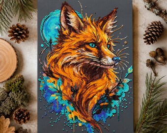 May include: A diamond painting kit featuring a fox head rendered in vibrant orange, brown, and yellow beads against a dark gray background. The fox has bright blue eyes and is surrounded by abstract splashes of turquoise and blue beads.