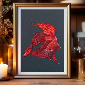 May include: A framed artwork featuring a red betta fish with flowing fins, depicted in a detailed, almost 3D style. The fish is set against a dark gray background.