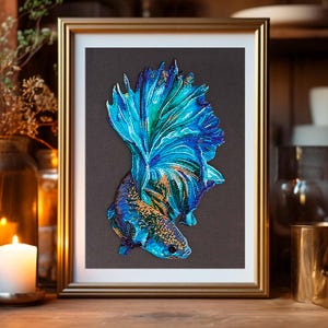 May include: A framed artwork depicting a blue and green betta fish with iridescent scales. The fish is shown with its fins spread out, creating a dramatic and colourful display.