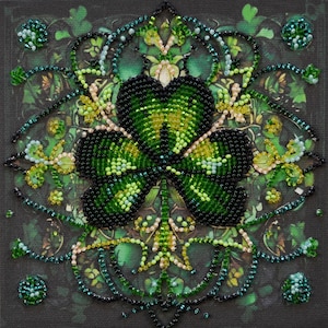 May include: A beaded artwork featuring a four-leaf clover design. The clover is primarily green and black, with accents of yellow and cream. The background is a dark green with a leafy pattern, and the piece is square.