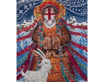 May include: A cross-stitch embroidery featuring a figure with braided hair wearing a brown and orange patterned garment, standing beside a white goat. The background displays a snowy village scene with red ribbons and white line art patterns.