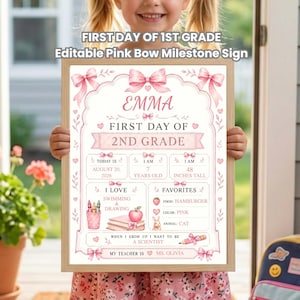 May include: A rectangular milestone sign with a light pink border and bow illustrations. The text reads: FIRST DAY OF 1ST GRADE, EMMA, FIRST DAY OF 2ND GRADE, AUGUST 20, 2026, 7 YEARS OLD, 48 INCHES TALL, SWIMMING & DRAWING, FAVORITES, HAMBURGER, PINK, CAT, A SCIENTIST, MS. OLIVIA.