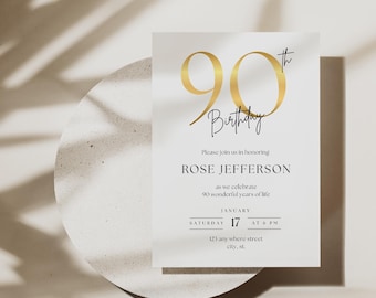 May include: A white invitation card with gold text and a gold '90th' graphic. The card reads 'Birthday' and invites guests to celebrate Rose Jefferson's 90th birthday on January 17th at 6 PM. The card is on a white, textured surface.