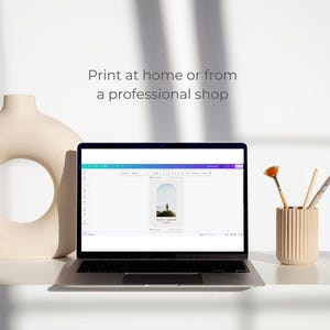May include: A laptop computer displaying a website with a design template for a wedding invitation. The template features a photo of a couple standing on a beach with a sunset in the background. The text on the template reads "Kate & John" and "October 2020".