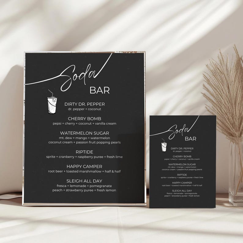 May include: Two black chalkboard signs with white text listing a menu of soda bar drinks. The signs are titled "Soda Bar" and list drinks like "Dirty Dr. Pepper", "Cherry Bomb", "Watermelon Sugar", "Riptide", "Happy Camper", and "Sleigh All Day".