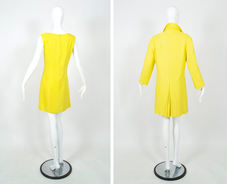 May include: A yellow sleeveless dress and a matching yellow coat. Both garments are made of a smooth, lightweight fabric.