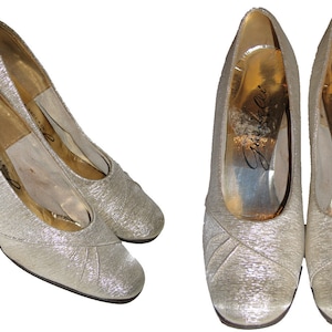 May include: A pair of silver sparkly high-heeled pumps with a square toe. The shoes are made by Gianelli and have a gold insole.