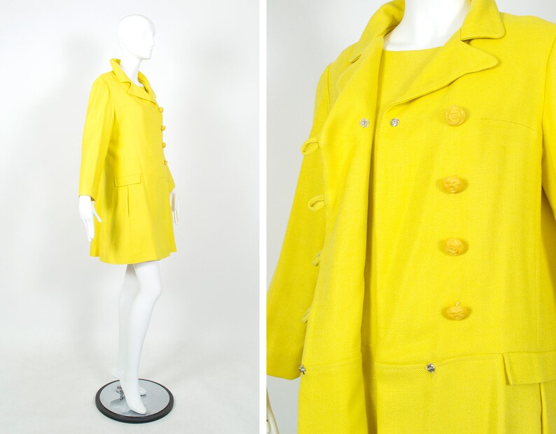 May include: A bright yellow coat and dress set with a double-breasted closure and four large yellow buttons. The coat has a long sleeve and a slightly flared skirt. The dress has a short sleeve and a straight skirt.