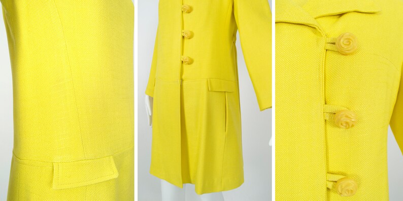 May include: A bright yellow coat with a long, straight silhouette and a row of large, yellow, rose-shaped buttons.