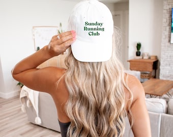 May include: White baseball cap with green text that reads "Sunday Running Club".