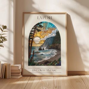 May include: A framed poster with a stained glass style illustration of a sunset over a beach with a mountain in the background. The text "LA PUSH" is at the top of the poster and the text "LIVE. OKAY? PLEASE." is at the bottom.