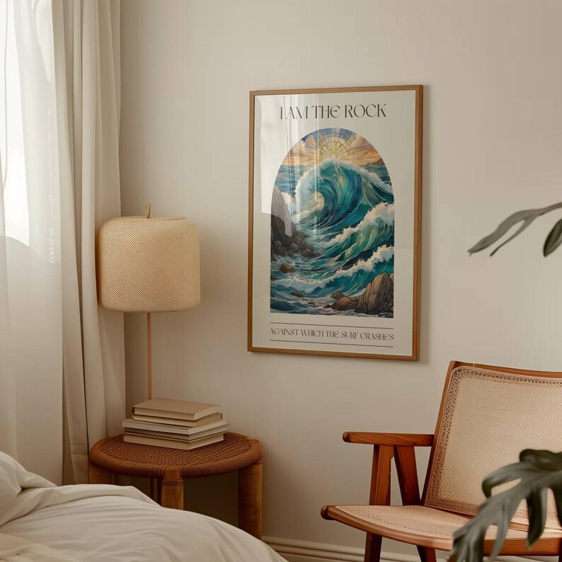 May include: A framed poster with a blue and green watercolor illustration of a wave crashing against a rocky shore. The text "I AM THE ROCK AGAINST WHICH THE SEA CRASHES" is printed below the image.