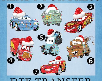 May include: DTF TRANSFER image featuring seven cartoon cars, each adorned with a Santa hat and Christmas lights. The cars are in various colors, including blue, red, and green, set against a light blue background. Text at the top reads "READY FOR PRESS".