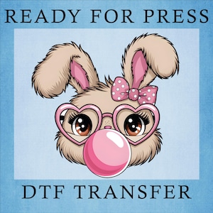 May include: A cartoon illustration of a bunny with heart-shaped glasses blowing a bubblegum bubble. The bunny has a pink bow and pink inner ears. The text "READY FOR PRESS" and "DTF TRANSFER" are at the top and bottom.