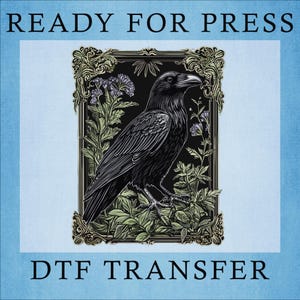 May include: A black and white illustration of a raven perched on a branch with green leaves. The raven is in a gold frame with ornate details. The text "READY FOR PRESS" is at the top of the image and "DTF TRANSFER" is at the bottom.