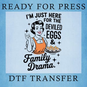 May include: A DTF transfer graphic featuring a retro-style person wearing an orange apron, holding a platter of deviled eggs. The text reads: READY FOR PRESS, I'M JUST HERE FOR THE DEVILED EGGS & FAMILY DRAMA, and DTF TRANSFER. Black ink on light blue.