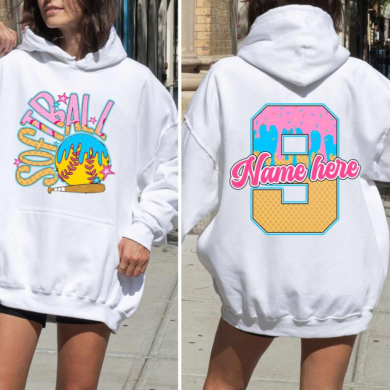 May include: White hoodie with a softball graphic on the front and a number 9 with the text "Name here" on the back. The softball graphic is blue, yellow, and pink with a dripping ice cream effect. The number 9 is yellow and blue with a waffle cone texture and pink and white sprinkles.