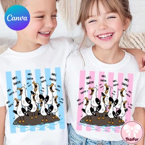 May include: Two white t-shirts featuring a graphic of multiple seagulls standing on a rock with their beaks open. The left shirt has light blue vertical stripes, and the right shirt has pink vertical stripes. Both shirts include the text Mrs. Smith!