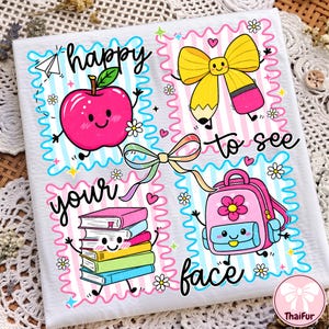 May include: A white fabric square featuring four colorful cartoon panels with the text happy to see your face. The illustrations include a pink apple, a yellow pencil bow, a stack of books, and a pink backpack, all accented with small flowers.
