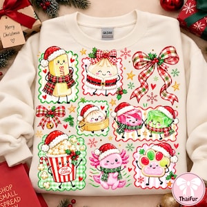 Puede incluir: Una sudadera de cuello redondo color crema con un estampado gráfico festivo de varios personajes de dibujos animados con gorros de Papá Noel, incluyendo mantequilla, dumplings, palomitas, un ajolote y una huella, con lazos y copos de nieve.