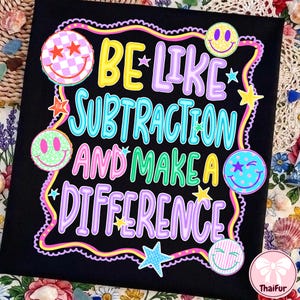 May include: A black t-shirt featuring the colourful text BE LIKE SUBTRACTION AND MAKE A DIFFERENCE. The design includes various smiley faces with patterns like checkers, leopard print, and stripes, along with small stars and a wavy border.