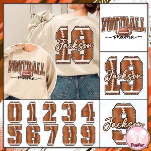 May include: A beige sweatshirt with a football-themed design. The back features a large number 19 in a football design with the name "Jackson" in a script font. The front has the words "FOOTBALL mama" with a football graphic. Additional football numbers are also shown.