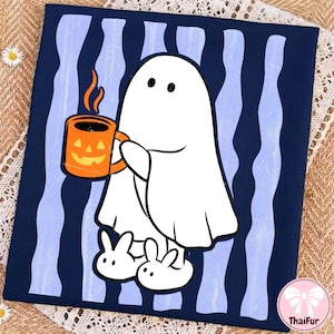 May include: A dark blue t-shirt featuring a white ghost character holding an orange jack-o'-lantern mug with steam rising from it. The ghost wears white bunny slippers. The background of the graphic consists of vertical light blue wavy stripes.