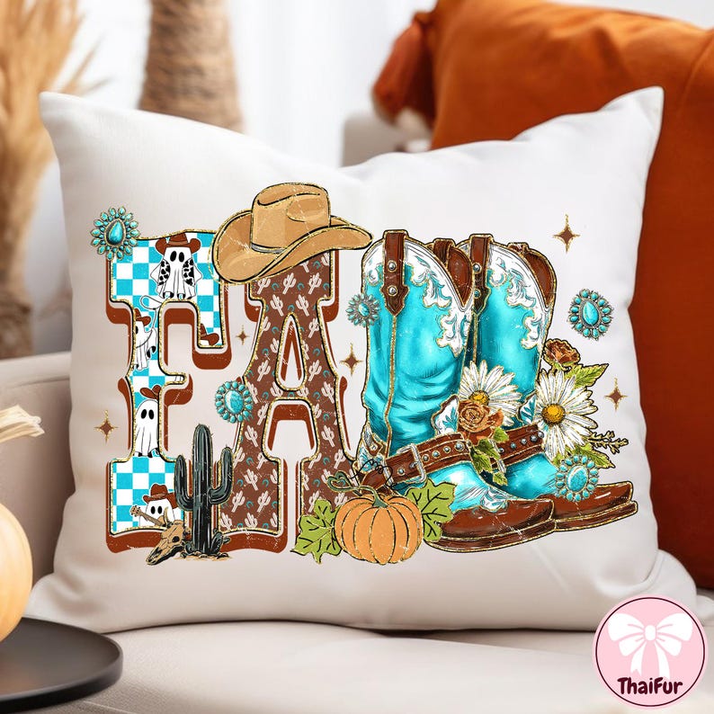May include: White decorative pillow with a "FA" design featuring a cowboy hat, turquoise boots, and a pumpkin. The letters are brown with a cactus and ghost design. The boots are turquoise and brown, with floral accents.