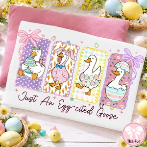 May include: White pillowcase with an Easter-themed design featuring four cartoon geese in colorful outfits, holding eggs, and wearing bunny ears. The text "Just An Egg-cited Goose" is written in cursive.