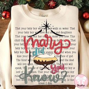 May include: Cream-colored sweatshirt with a graphic design featuring the words "Mary Did You Know?" in various colors, along with a nativity scene and a star. The text is surrounded by a longer passage.