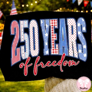 May include: Black t-shirt with a patriotic design. The design features the text "250 YEARS of freedom" in red, white, and blue, with stars and stripes patterns. The number "250" is prominently displayed.