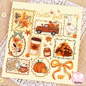 May include: A sticker sheet featuring autumn-themed illustrations including a truck, a goose, a coffee cup, a candle, a pile of leaves, pumpkins, cinnamon rolls, and a bow. The text "Hello fall" is printed in orange script at the top of the sheet.