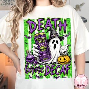 May include: An off-white t-shirt featuring a graphic of a ghost wearing a witch hat, holding a purple energy drink can labeled Witch's Brew, with a jack-o'-lantern, potion bottles, bats, and the text Death before DECAF in purple and green.