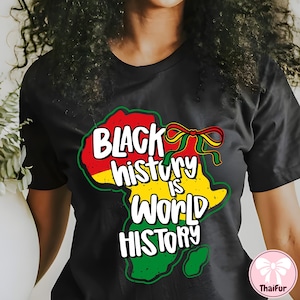 May include: Black t-shirt with a colorful graphic of the African continent in red, yellow, and green. The text "BLACK history IS WORLD HISTORY" is written in white, with a ribbon design.