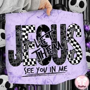 May include: A purple and white graphic with the words "JESUS LET THEM SEE YOU IN ME". The word "JESUS" is in a black checkered pattern, and the words "LET THEM" are in a black leopard print. Small crosses are placed throughout the design.