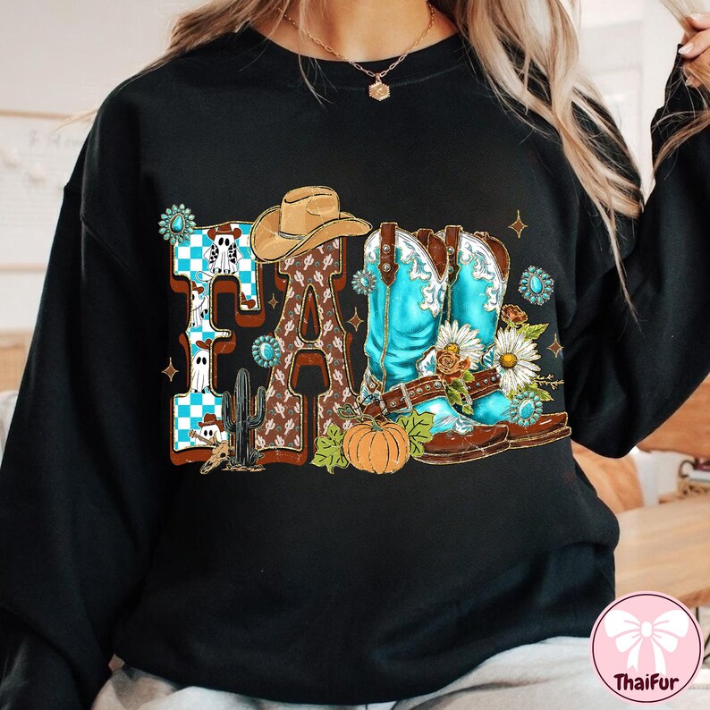May include: Black sweatshirt with a colorful "FALL" graphic. The design features a cowboy hat, turquoise cowboy boots, a pumpkin, and floral accents. The letter "F" has a blue and white checkered pattern, and the letter "L" has a brown pattern.