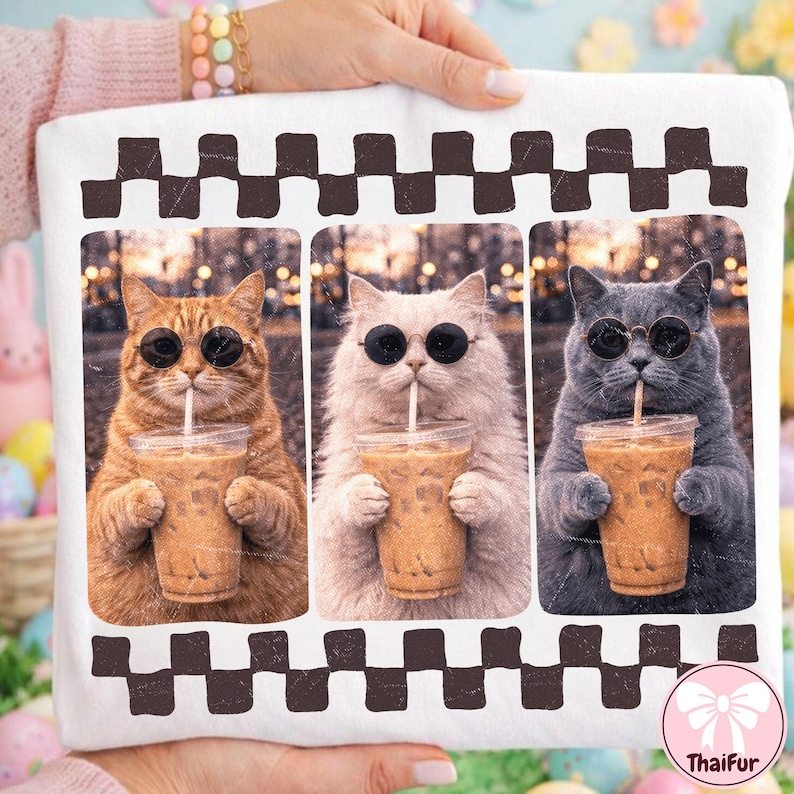 May include: White t-shirt featuring three cats wearing sunglasses and drinking iced coffee. The cats are in separate frames with a brown and black checkered border. The ThaiFur logo is in the bottom right corner.