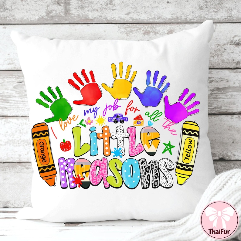 May include: White throw pillow with a colorful design featuring handprints, crayons, and the text "I love my job for all the little reasons." The design includes a car, house, and apple.