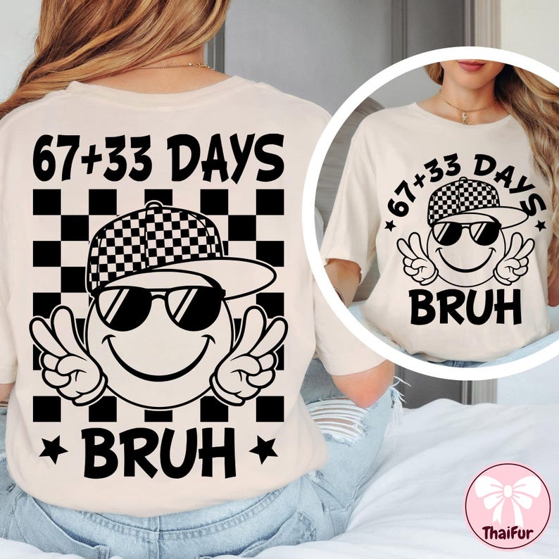May include: Cream-colored t-shirt featuring a graphic of a smiley face wearing sunglasses and a checkered hat, with the text "67+33 DAYS BRUH". The design includes peace signs and stars.